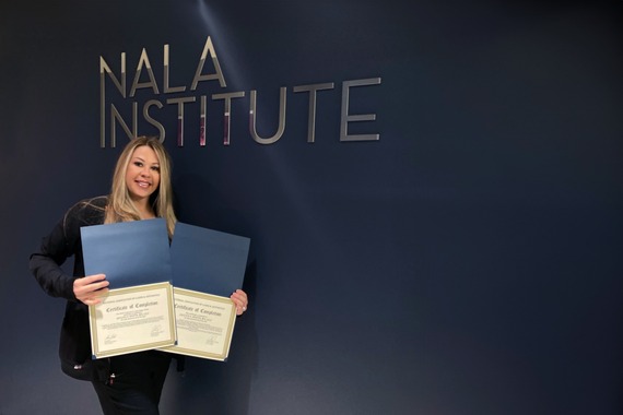 Jaclyn holding her certificates of graduation from NALA's advanced laser courses